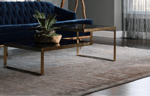 Modern living room with a brass coffee table and blue velvet sofa.